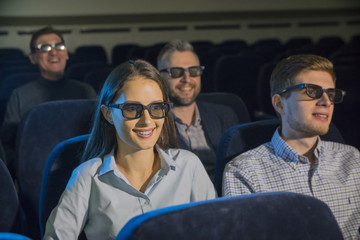 Fototapeta na wymiar people, a guy with a girl watching a movie at the cinema