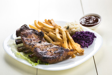 baked ribs and French fries and cabbage salad