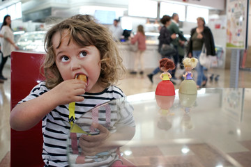 girl eating a cake in a coffee house