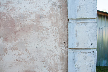 the dilapidated corner of the house strictly with traces of paint and cracks