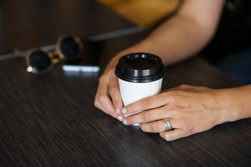women's hands and a glass of coffee, the concept of coffee with you