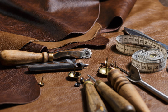 Premium Photo  Tools for leather crafting and pieces of brown leather