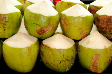 Fresh young coconuts. Pile tropical young coconut (soft focus) for drink background