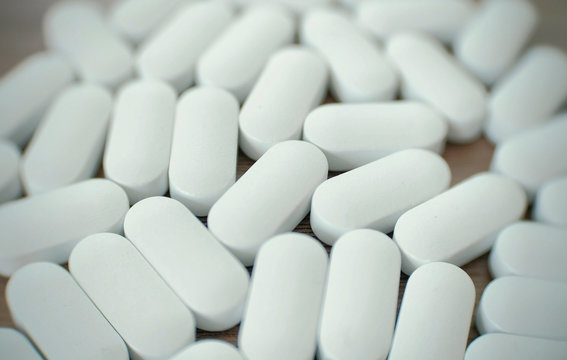 White pills on the table.