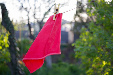 a red rag is dried on a rope and clothespin