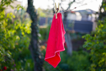 a red rag is dried on a rope and clothespin