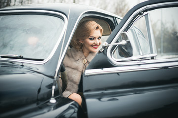 Fototapeta na wymiar Retro collection car and auto repair by driver. sexy woman in fur coat. Travel and business trip or hitch hiking. Escort and security guard for luxury woman. Call girl in vintage car