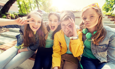 friendship and people concept - happy teenage friends or high school students having fun and making...