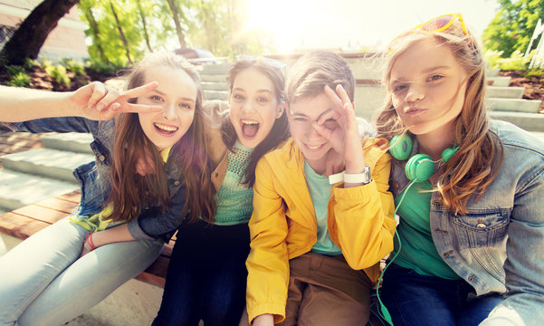 friendship and people concept - happy teenage friends or high school students having fun and making faces