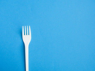 Plastic fork pattern on blue background