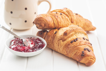 Two croissants with chocolate crumbs.
