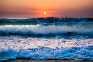 Big sea waves at sunset