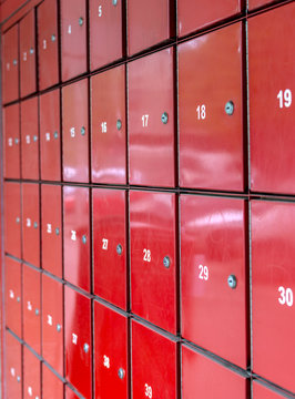 Group Of Red Letterbox In A Post Office With Number Range.