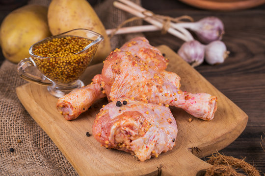 Marinated chicken legs with raw potatoes and garlic