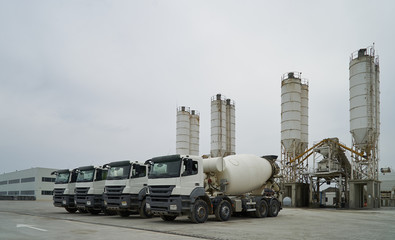 Concrete factory with silos and trucks. Concrete mixing silo, site construction facilities....