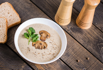 A bowl of mushroom soup cream on the table