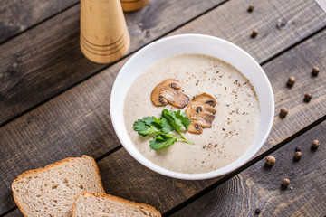 A bowl of mushroom soup cream on the table