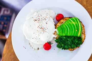 breakfast with mascarpone cheese, cherry tomatoes, avocado and toast