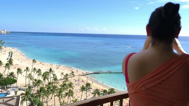 Professional video of woman taking picture of Waikiki beach in Hawaii in 4K slow motion 60fps