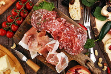 Italian antipasti wine snacks set. Cheese variety, Mediterranean olives, pickles, Prosciutto di Parma and salami