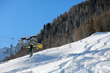 Fototapeta na wymiar Chair lift. Ski lift chair engine by misty snowy day in mountains area. Alpe Liusia, Trentino Alto Adige, Moena, Val di Fassa, Dolomites, Italy.