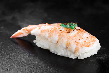 Sushi nigiri with shrimp on black background