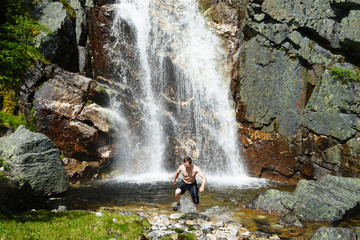 A man run away out of cold waterfall.