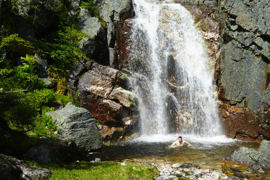 A man run away out of cold waterfall.