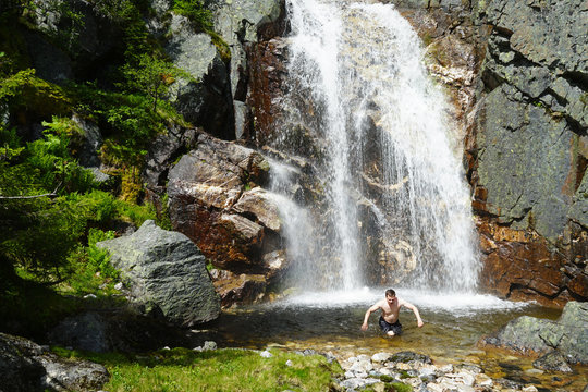 A man run away out of cold waterfall.
