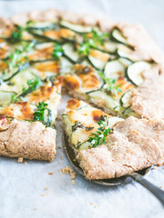 Savory zucchini and cheese galette on spelt dought, served with fresh thyme