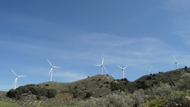 Wind turbines of renewable energy moving in the mountain
