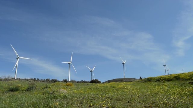 Wind turbines of renewable energy moving in the mountain