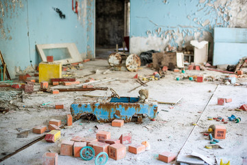 Abandoned kindergarten in Chernobyl Exclusion Zone. Lost toys, A broken doll. Atmosphere of fear and loneliness. Ukraine, ghost town Pripyat.
