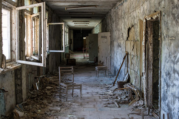 Fototapeta na wymiar Corridor of abandoned middle school in Pripyat city in Chernobyl Exclusion Zone, Ukraine