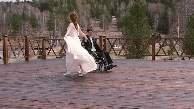Groom in a wheelchair dancing the first dance with the bride.