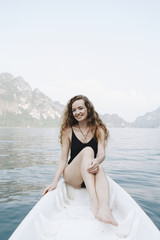 Fototapeta na wymiar Woman relaxing on a canoe at a lake