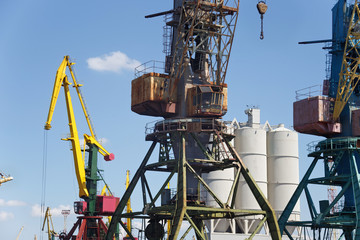 Fototapeta na wymiar Heavy harbour jib cranes in the Kaliningrad Sea Fishing Port.