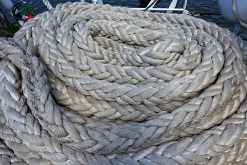 Fototapeta na wymiar Thick white ropes on a sailing ship.