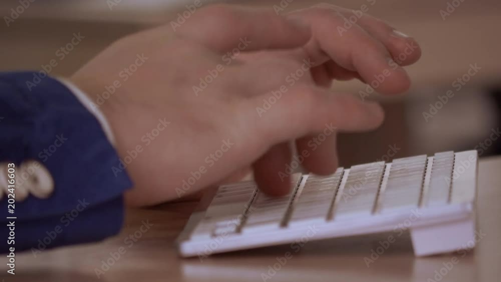 Poster close up details man hands typing on white keyboard. unrecognizable person working on computer