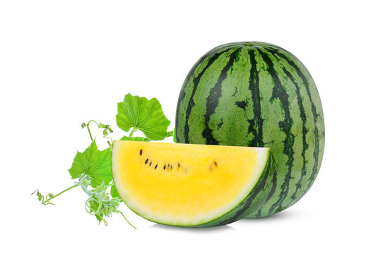 whole and slice yellow watermelon with green leaf isolated on white background