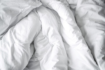 Unattended white cozy bed with white soft big pillow bedroom background.