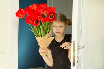 Beautiful little girl holding bouquet of flowers