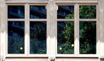 wooden window architecture with green reflection in the glass