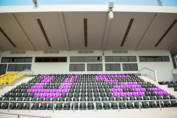 Many chairs in football stadium.