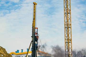 Construction machine, designed for immersion piles into the ground using the hammer, the hammer...