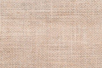 Fototapeta na wymiar Jute hessian sackcloth woven burlap texture background in sepia cream old aged brown color