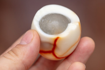 Boiled egg peeled and bitten in the hand