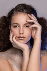 Beautyful girl with glitter on her face