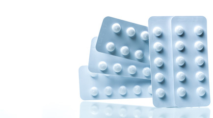 Colchicine 0.6 mg tablets pills in light resistant packaging isolated on white background. Gout...
