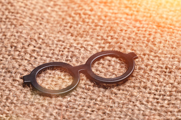 Glasses a magnet or sticker on sackcloth close up
